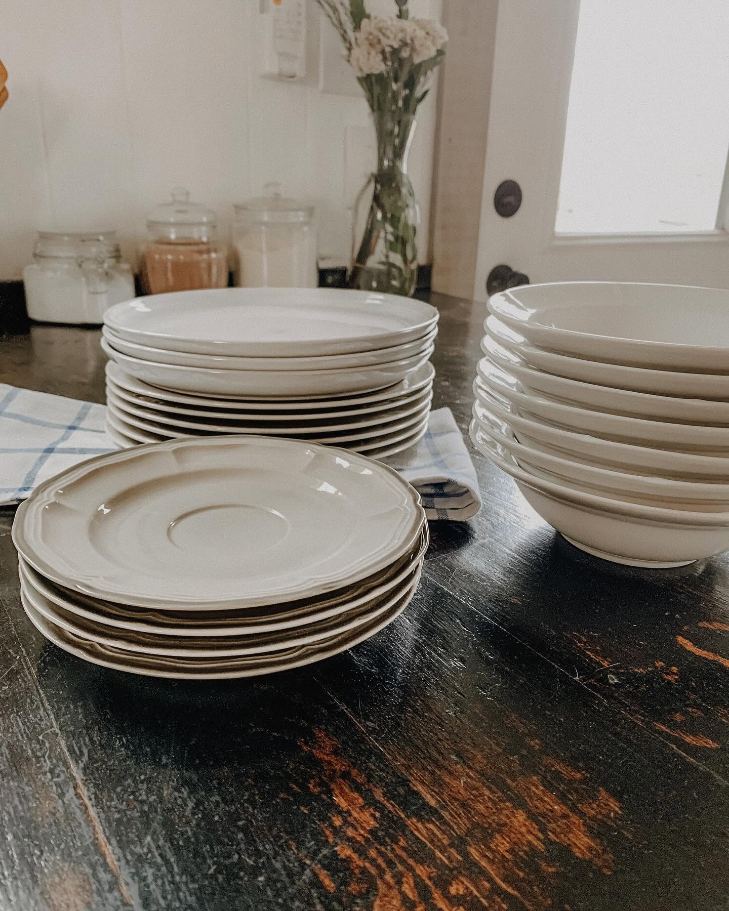 Stacked cream plates on farmhouse table
